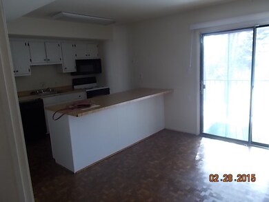 Kitchen with eat in area and exits to balcony