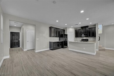 Kitchen featuring black appliances, light wood-typ