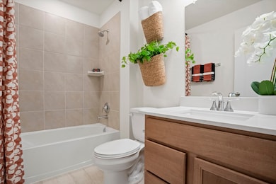 Secondary bath features porcelain tile flooring, b