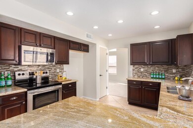 52. Kitchen w granite and SS appliance