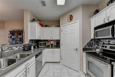 Kitchen featuring white cabinetry, sink, tasteful 