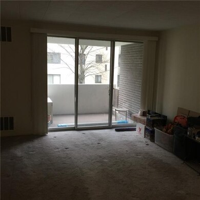 Spacious living room with glass door entrance to b