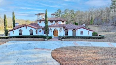 Mediterranean / spanish house featuring stucco siding, a chimney, and a tile roof