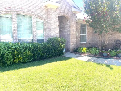 View of exterior entry featuring a lawn