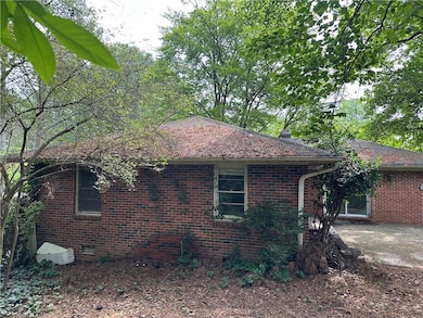 View of side of home featuring a patio area and br