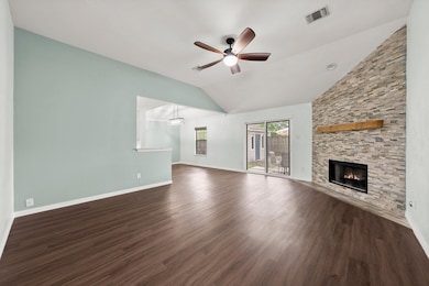 Unfurnished living room with a ceiling fan, vault