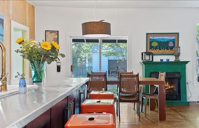 Dining space with a warm lit fireplace and wood f