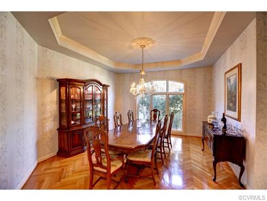 The herringbone patterned hardwood flooring contin