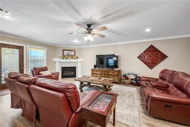 Living area featuring gas log fireplace, wood type