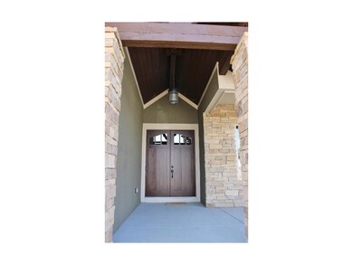 Beautiful double doors and beams highlight this fr