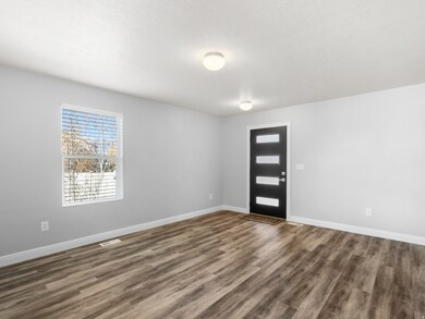 Entryway featuring dark wood-style flooring and baseboards