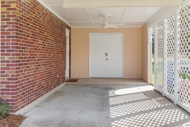 Doorway to property featuring ceiling fan