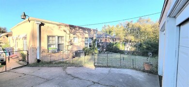 View of property exterior featuring stucco siding and a gate