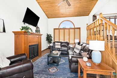 Living room with vaulted ceiling, ceiling fan, har