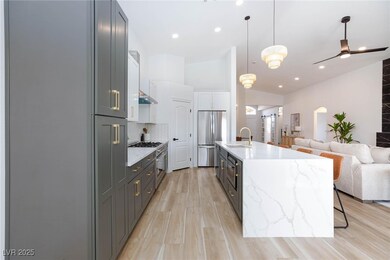 Kitchen with a center island with sink, hanging li