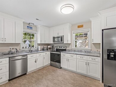 Updated Kitchen with granite countertops, stainless steel appliances, newer cabinets and vinyl floors