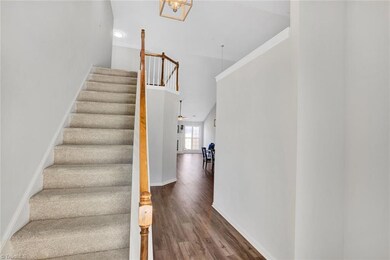 Foyer with stairs up to Loft (could make a great office), third full bathroom and bedroom.