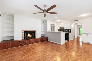 Unfurnished living room with a tile fireplace, li