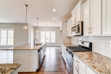 Kitchen with granite counters and subway tile back