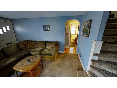 Living Room. Hardwoods under carpet.  Arched doorw