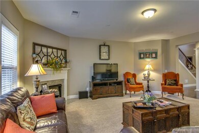 This large great room boasts plenty of room, natural light and a gas fireplace.