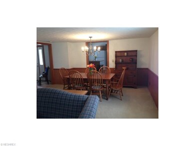 Formal Dining room with newer carpet, wainscoting,