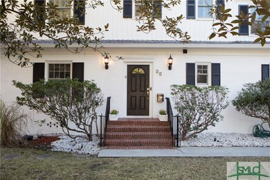 Brick front stoop with beautiful landscaping. Perf