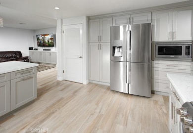 The cook in the family will appreciate the bright and spacious remodeled kitchen with its sparkling picture window, shaker cabinetry, self-closing doors/drawers, pots and pans drawers, walk-in pantry, quartz countertops, custom subway tiled backsplas