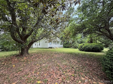 View of green lawn featuring a porch