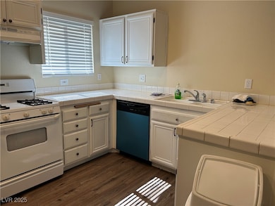 Kitchen featuring white range with gas stovetop, r