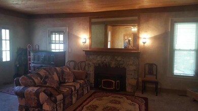 Savannah Rd Living Room with rustic stone fireplac