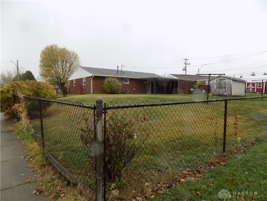 Large backyard with a covered patio and shed
