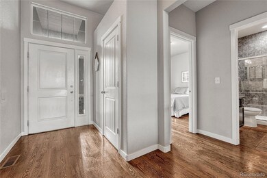 Front Entry with coat closet and view into Front Bedroom and adjacent Bathroom.