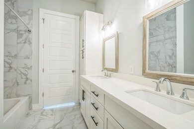 Full bathroom featuring marble finish flooring, d