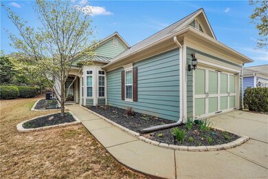 View of side of home featuring a garage and concrete driveway