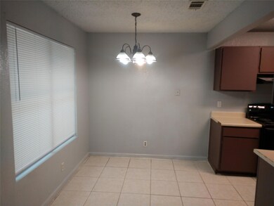 Unfurnished dining area with a chandelier, a text