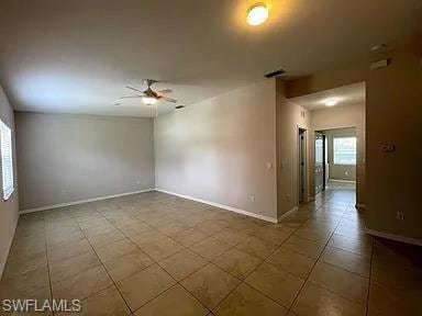 Tiled spare room with visible vents, plenty of nat
