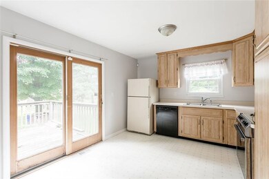Kitchen with sliding door an enclosed deck.