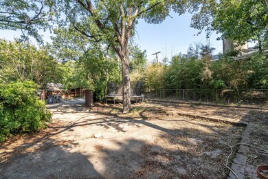 View of yard featuring a trampoline and a fenced b