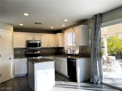 Kitchen with stainless steel appliances, a sink, h