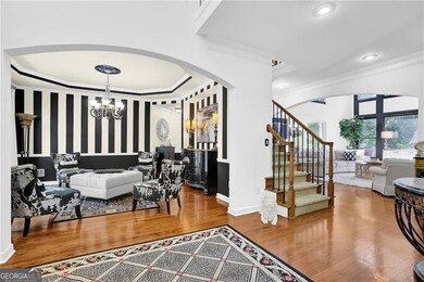 Foyer entrance with arched walkways, crown molding