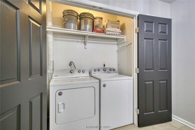 Washroom featuring washer and clothes dryer and light tile patterned floors