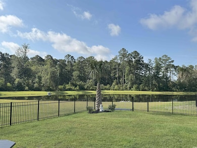 Fenced backyard featuring a water view