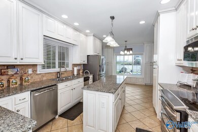 Gourmet Kitchen contains an abundance of cabinets w/ iisland, stainless appliances, tile, smooth ceilings & recessed lighting. Lots of natural light.Also has a large eat in area adjacent to bay window w/view heated in ground pool.  Friends entrance.
