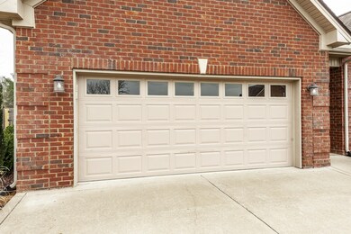 Front Entry 2-Car Garage with Concrete Driveway and Extra Parking Area.