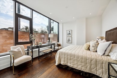 This contemporary primary bedroom suite features a