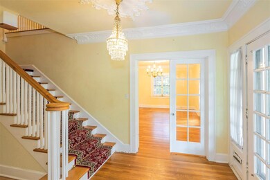 Entry hall with grand staircase, formal drawing ro