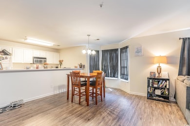 Dining area featuring light hardwood / wood-style flooring and an inviting chandelier