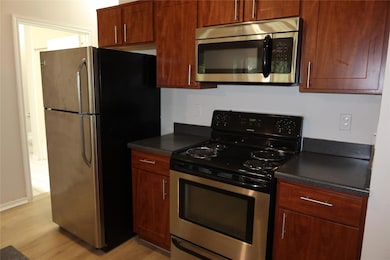 Kitchen featuring stainless steel appliances, dar