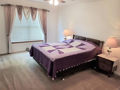 Large Master bedroom w ceiling fan and double wind